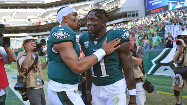 Philadelphia Eagles stars Jalen Hurts and A.J. Brown leave the field after a game against the Washington Commanders.